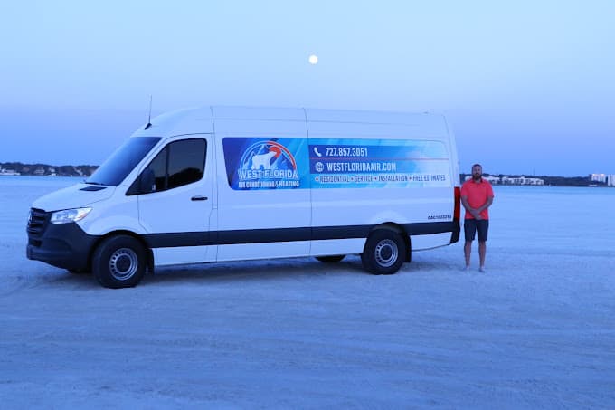 Ryan Ferguson with West Florida Air service van on the beach